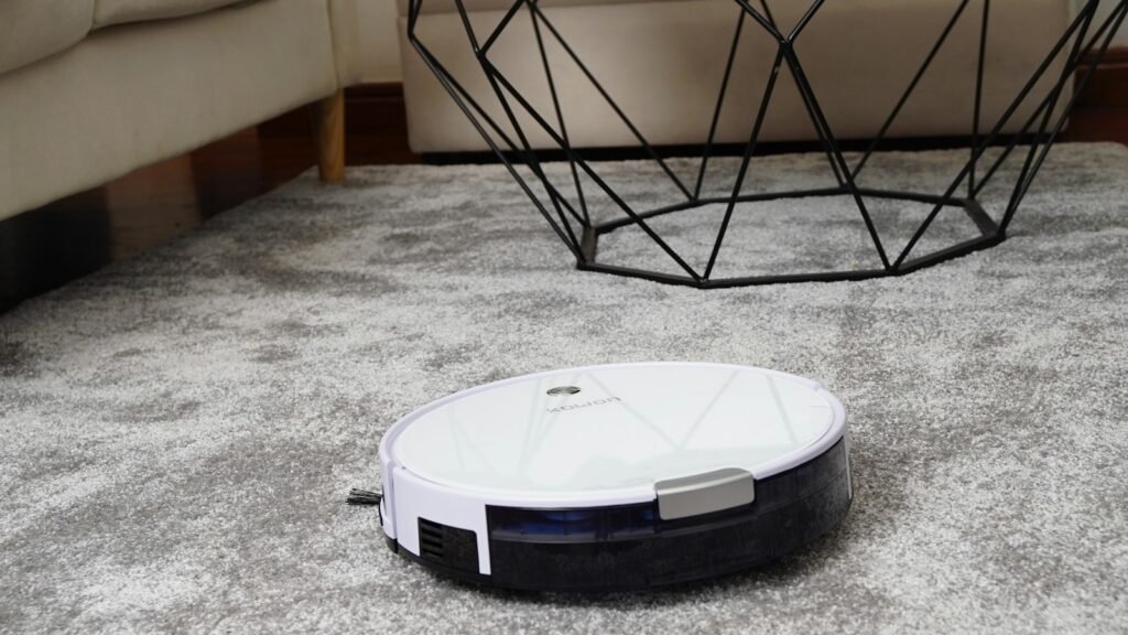 Robot aspirateur blanc sur un tapis